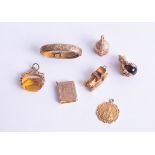 Six various 9ct gold charms and a 9ct buckle, (7) approx 20g.