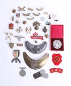 An assortment of various loose cap badges, including King's, Stafford, ATF cloth patch, a French
