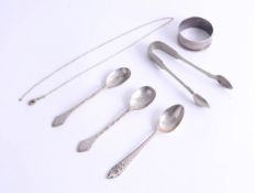 A pair of silver rat-tail teaspoons, another silver teaspoon, with crest IGI and a silver napkin