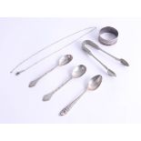 A pair of silver rat-tail teaspoons, another silver teaspoon, with crest IGI and a silver napkin