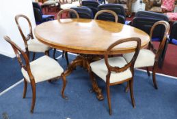 A Victorian burr walnut oval tip up top table on a pedestal carved base, together with six walnut-