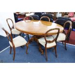 A Victorian burr walnut oval tip up top table on a pedestal carved base, together with six walnut-