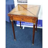 A 19th century mahogany and parquetry inlaid envelope games table, the top with baize insert and