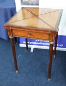 A 19th century mahogany and parquetry inlaid envelope games table, the top with baize insert and