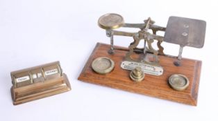 A vintage set of scales and weights, the plaque marked 'Inland Letter Rates', together with a