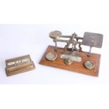 A vintage set of scales and weights, the plaque marked 'Inland Letter Rates', together with a