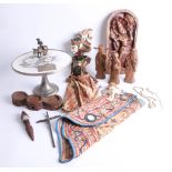 An interesting collection of eastern wood carvings, carved wooden plaques, doll, porcelain cake
