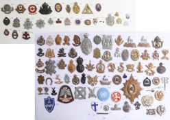 A collection of approx. 100 military cap and other badges displayed on two sheets including WWII