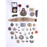 A collection of various cap badges, buckles and objects including British, Scottish, German etc.