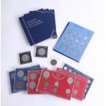A collection of various British coins, including GB shillings 1953 to date, blue folder sets,