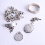 A heavy silver charm bracelet, locket, bangle, coin pendant and ID bracelet.