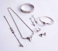 A contemporary silver jewellery set, bangle, earrings, pendant, necklace and ring, together with a