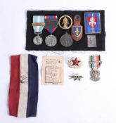 A collection of various loose badges and some French medals including Cameroon legion medal etc.