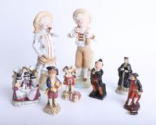 A pair of German porcelain figures, a Doulton small Dickensian figure, Portia figure and other