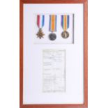 Three Great War medals, framed with certificate of discharge, Frank Gould (b1894) (medals not named)