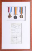 Three Great War medals, framed with certificate of discharge, Frank Gould (b1894) (medals not named)