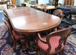 A heavy mahogany extending dining table of Victorian design, with two extension leaves on fluted