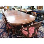 A heavy mahogany extending dining table of Victorian design, with two extension leaves on fluted