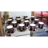 Royal Doulton, a Victorian set of fourteen teacups and saucers, with gilt decoration on a deep