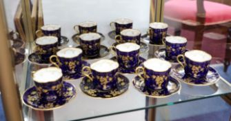 Royal Doulton, a Victorian set of fourteen teacups and saucers, with gilt decoration on a deep