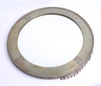 A circular hammered brass mirror of arts and crafts design.