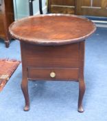 A polished mahogany sewing table.