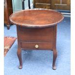 A polished mahogany sewing table.