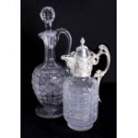 A silver-plated and ornate glass claret jug and a cut glass decanter.