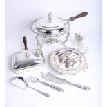 A silver plated ornate food warmer on spirit stand, together with other food warmers, serving