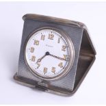 A silver cased travel clock with inscription dated 1929, 'Token of affection', the clock with