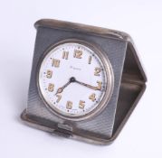 A silver cased travel clock with inscription dated 1929, 'Token of affection', the clock with