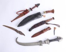 Five various knives including a kukri, a middle eastern short knife and daggers. Part of the Late