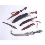 Five various knives including a kukri, a middle eastern short knife and daggers. Part of the Late