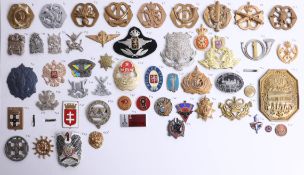 A collection of approx. 63 German, Austrian, Russian and other foreign military cap badges. Part