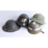 Four helmets including Chinese Jin Dong, Chinese pith helmet and English WWII helmet. Part of the