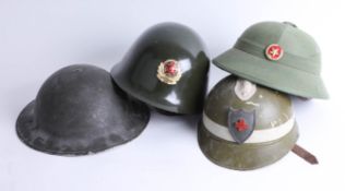 Four helmets including Chinese Jin Dong, Chinese pith helmet and English WWII helmet. Part of the