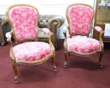 A pair of late Victorian open elbow chairs, upholstered in plush pink patterned upholstery.