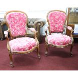 A pair of late Victorian open elbow chairs, upholstered in plush pink patterned upholstery.