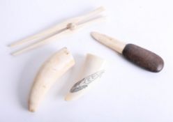 Two antique sperm whale tusks, glove stretcher and a marine bone knife (4).