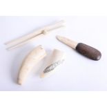 Two antique sperm whale tusks, glove stretcher and a marine bone knife (4).