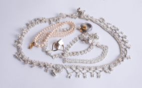 An eastern white metal necklace set, string of faux pearls, designer ring and earrings.