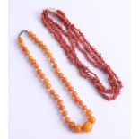 An amber style necklace together with a coral necklace, 13.7g.