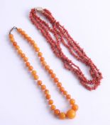 An amber style necklace together with a coral necklace, 13.7g.