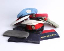 A collection of various caps and berets, including UN, Chinese and War vets. Part of the Late