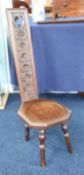 A carved oak spinning chair , height 90cm.