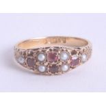 An 18ct yellow gold ruby and pearl set ring, size N.