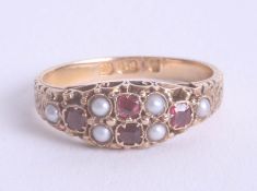 An 18ct yellow gold ruby and pearl set ring, size N.