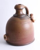 A large Dartington Artisan earthenware jug with stopper, height 33cm.