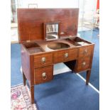 A Georgian mahogany gentleman's dressing table with fitted interior, three dummy and two real