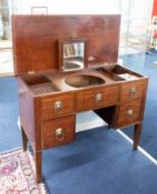 A Georgian mahogany gentleman's dressing table with fitted interior, three dummy and two real